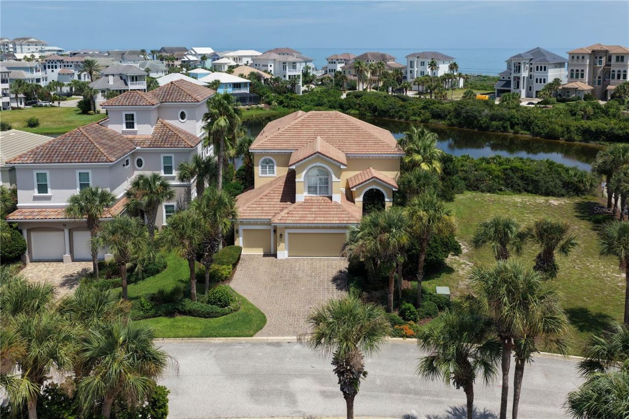 Photo 1 of 20: It starts with the setting. 27 Sandpiper Lane rests along the lake in Ocean Hammock
