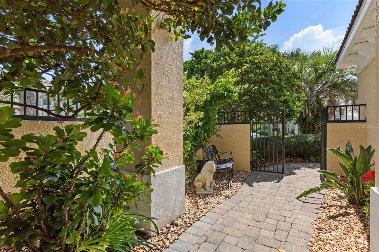 Photo 13 of 20: Beyond the gate, the entry opens into a garden courtyard, creating a beautiful pause between the outside world and home.
