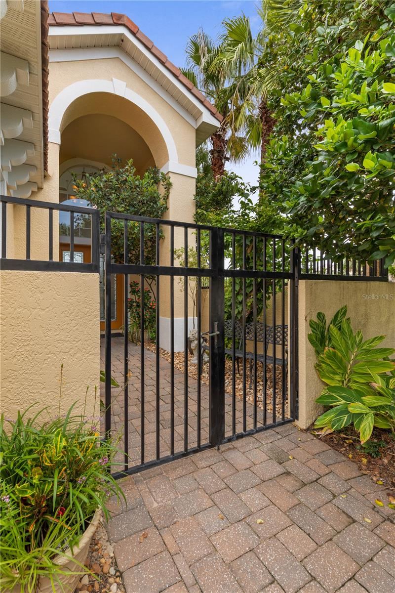 Photo 12 of 20: The sense of arrival begins before the front door, as a private gate draws you into the home’s tucked-away entrance.