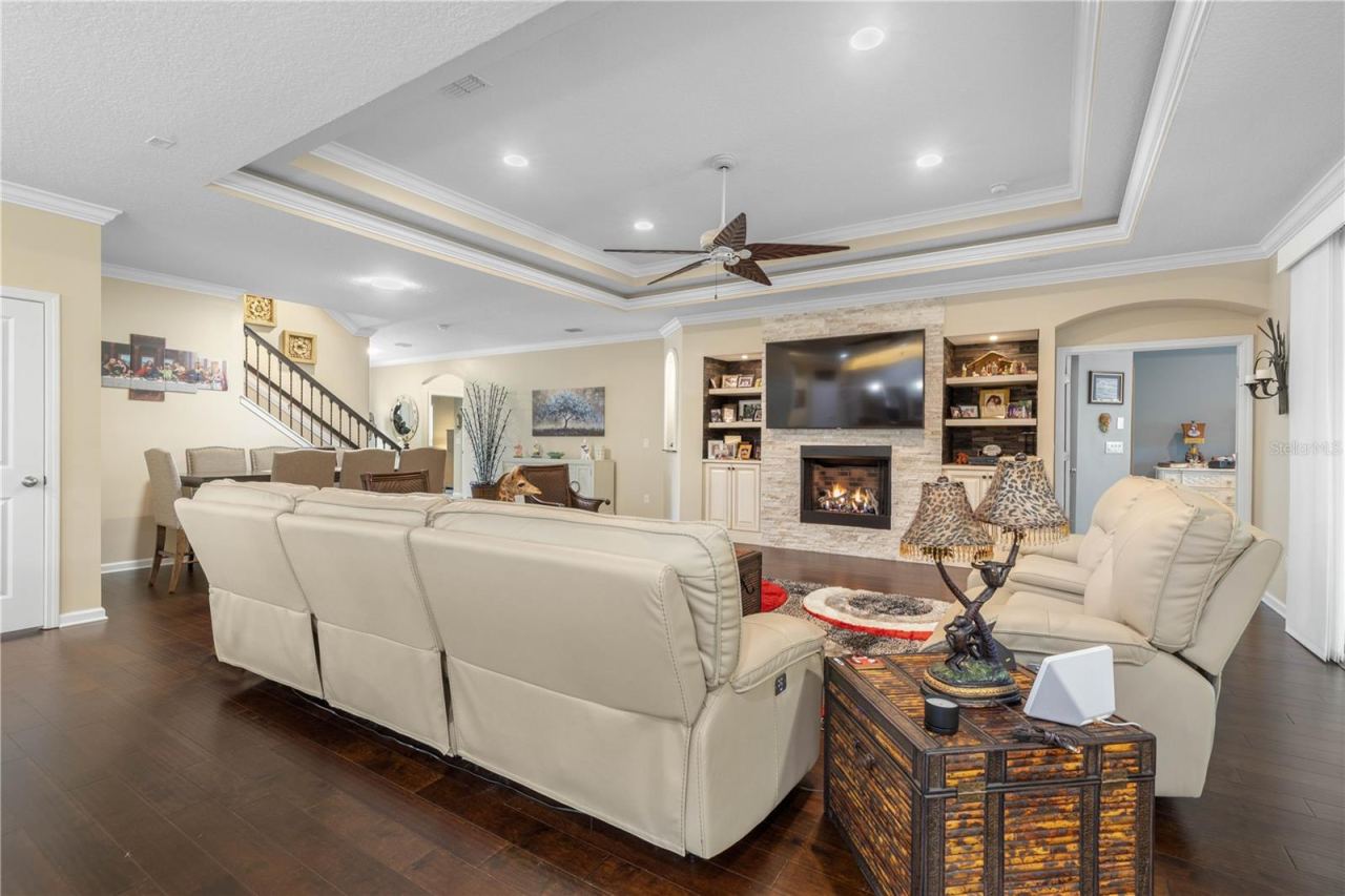 Photo 18 of 20: Designed for the way you really live—this generous gathering space offers plenty of room to stretch out, relax, and enjoy time together around the fireplace.