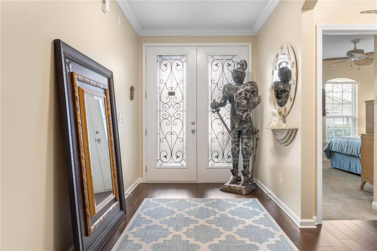 Photo 13 of 20: A bright, welcoming entry makes a lovely first impression, with a decorative glass front door and rich wood flooring leading you into the home.