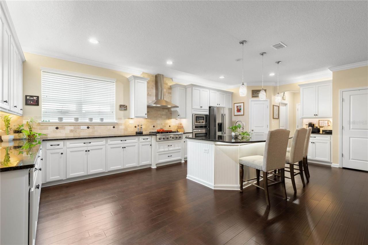 Photo 19 of 20: A chef’s kitchen that’s ready to impress, with generous prep space, a gas range, sleek stainless appliances, and an island that puts the cook right at the center of the action.