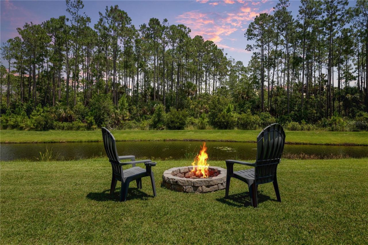 Photo 5 of 20: End the day fireside, where peaceful water views and a wooded backdrop turn an ordinary evening into your favorite place to unwind.