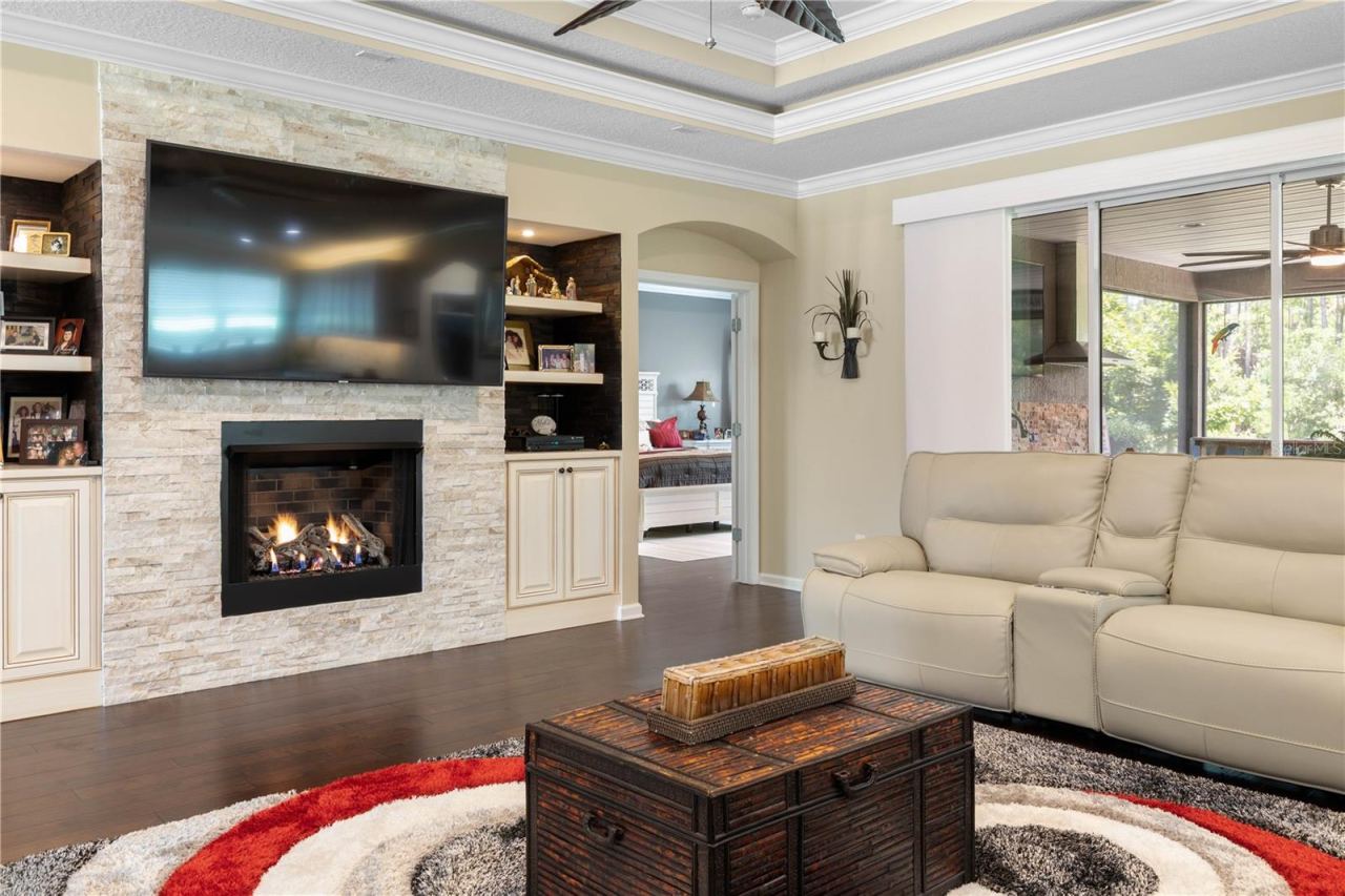Photo 16 of 20: Movie night, game day, or a quiet evening in—the stone-accented gas fireplace and built-ins create a cozy centerpiece for enjoying it all