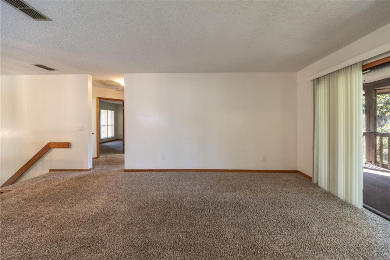 Photo 12 of 20: UNSTAGED: Carpeted Living Area. Professionally Cleaned