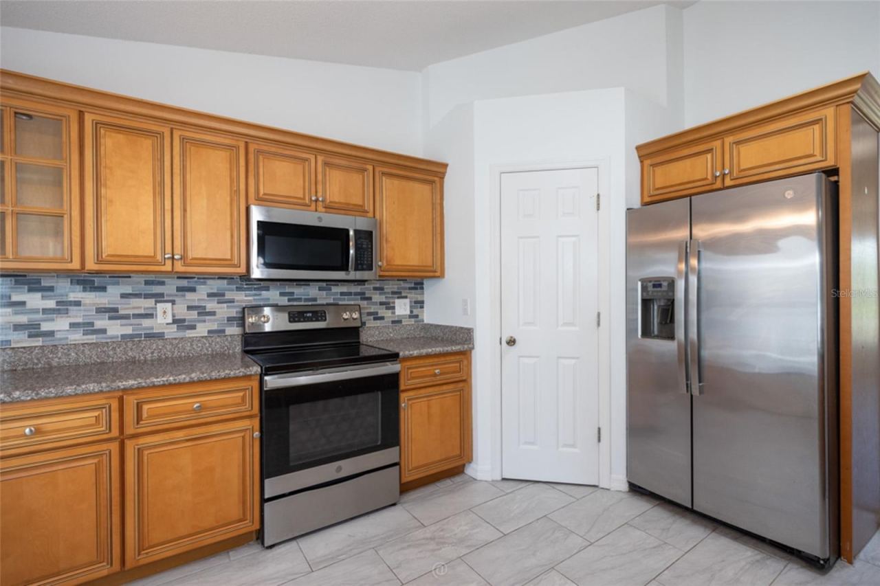 Photo 13 of 20: matching appliances, roomy pantry and glass tile backsplash