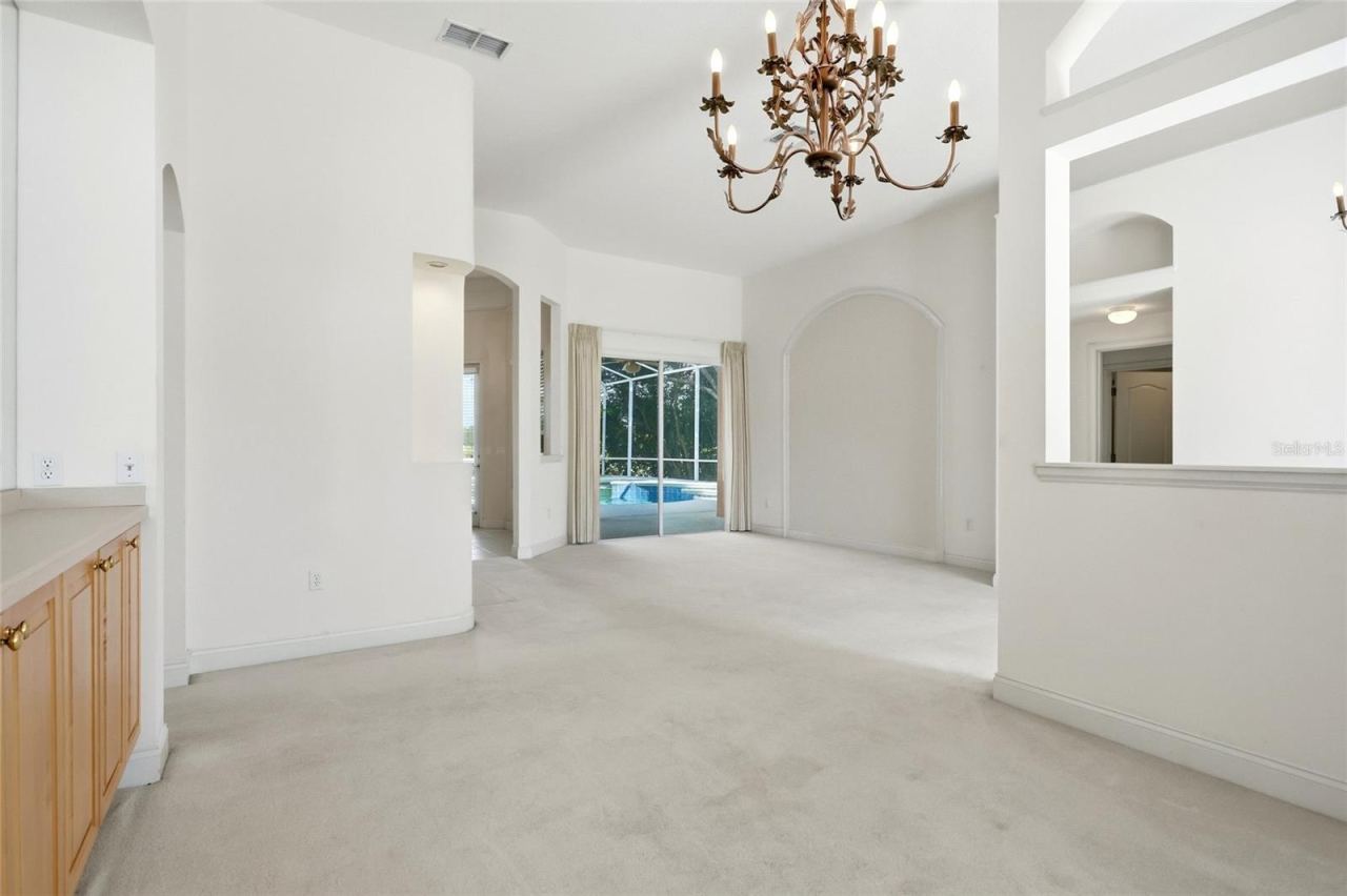 Photo 7 of 20: Separate formal living and dining rooms feature high ceilings, with sliding glass doorsconnecting the living room to the pool area.