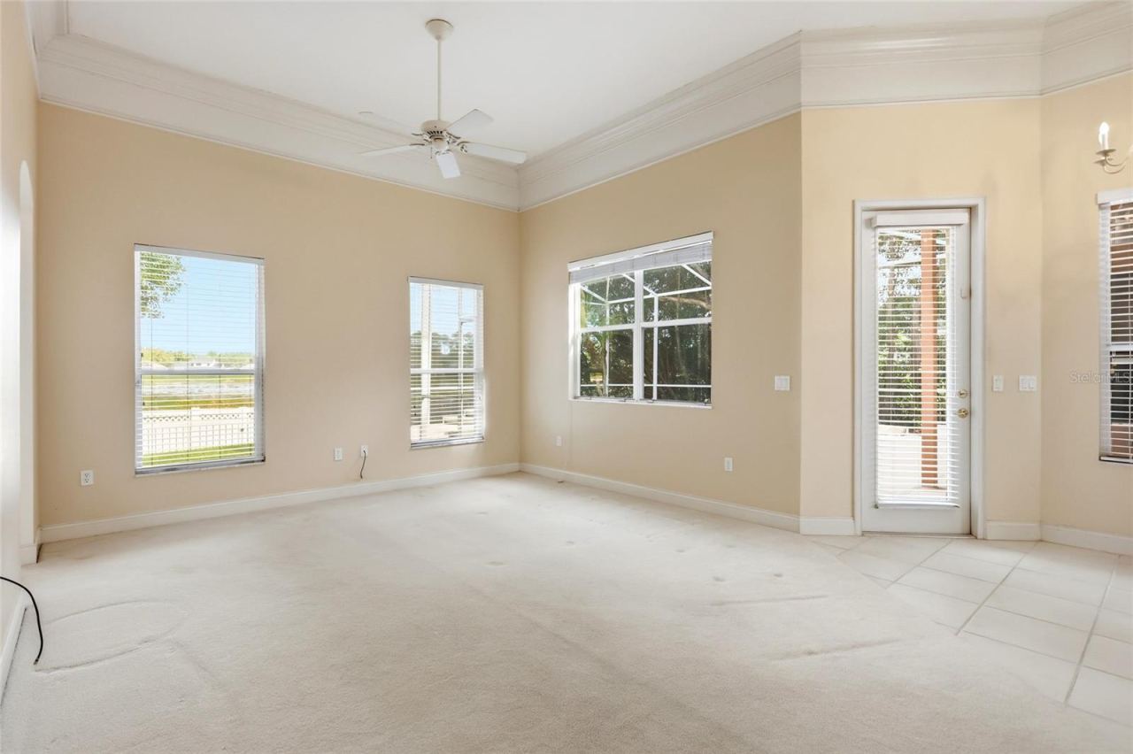 Photo 12 of 20: Lake views and natural light complement the family room, with crown molding and aconnection to the outdoor living spaces.