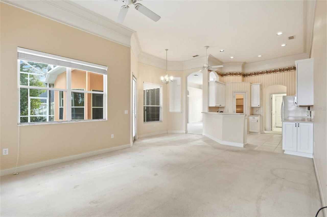 Photo 4 of 20: The family room opens to the kitchen and breakfast nook, with direct access to the coveredporch and screened pool.