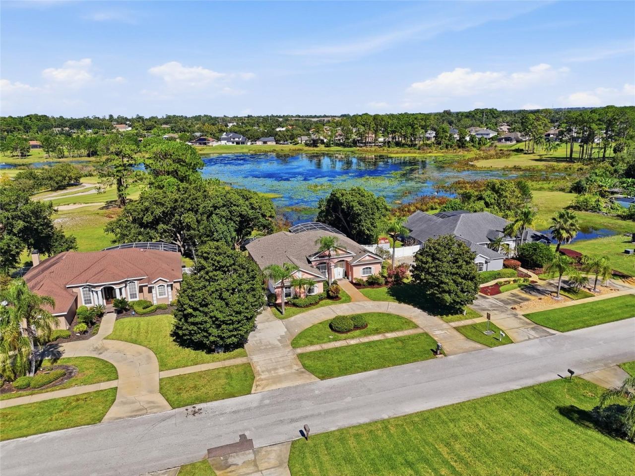 Photo 5 of 20: Elevated lake-view setting on approximately 0.47 acre in Glen Abbey, with mature trees anda circular driveway.