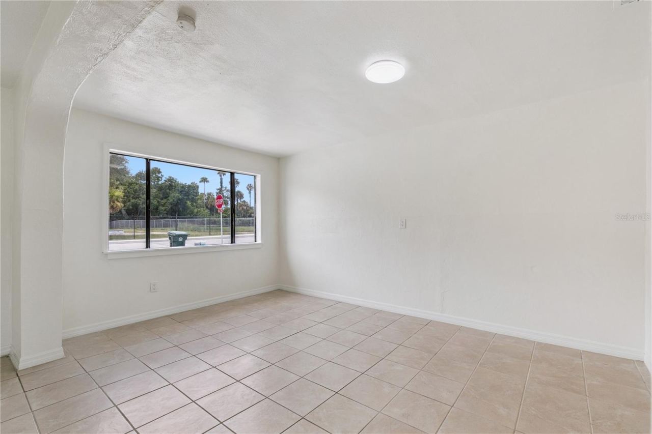 Photo 3 of 20: Bright and Spacious Living Area with Tile Flooring and Natural Light