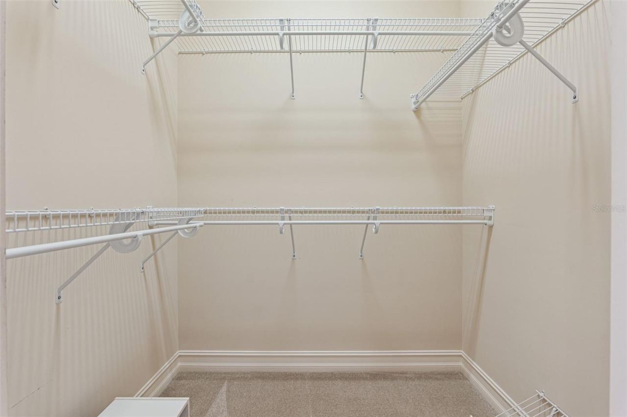 Photo 20 of 20: 1 of 2 walk-in closets for Primary Bedroom
