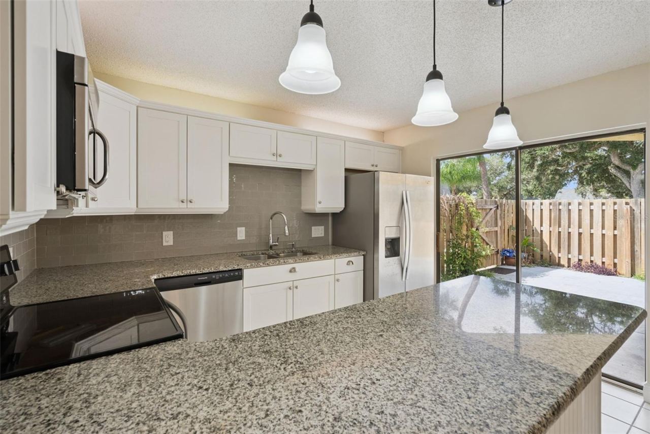 Photo 19 of 20: Kitchen with view to Fenced-In Courtyard