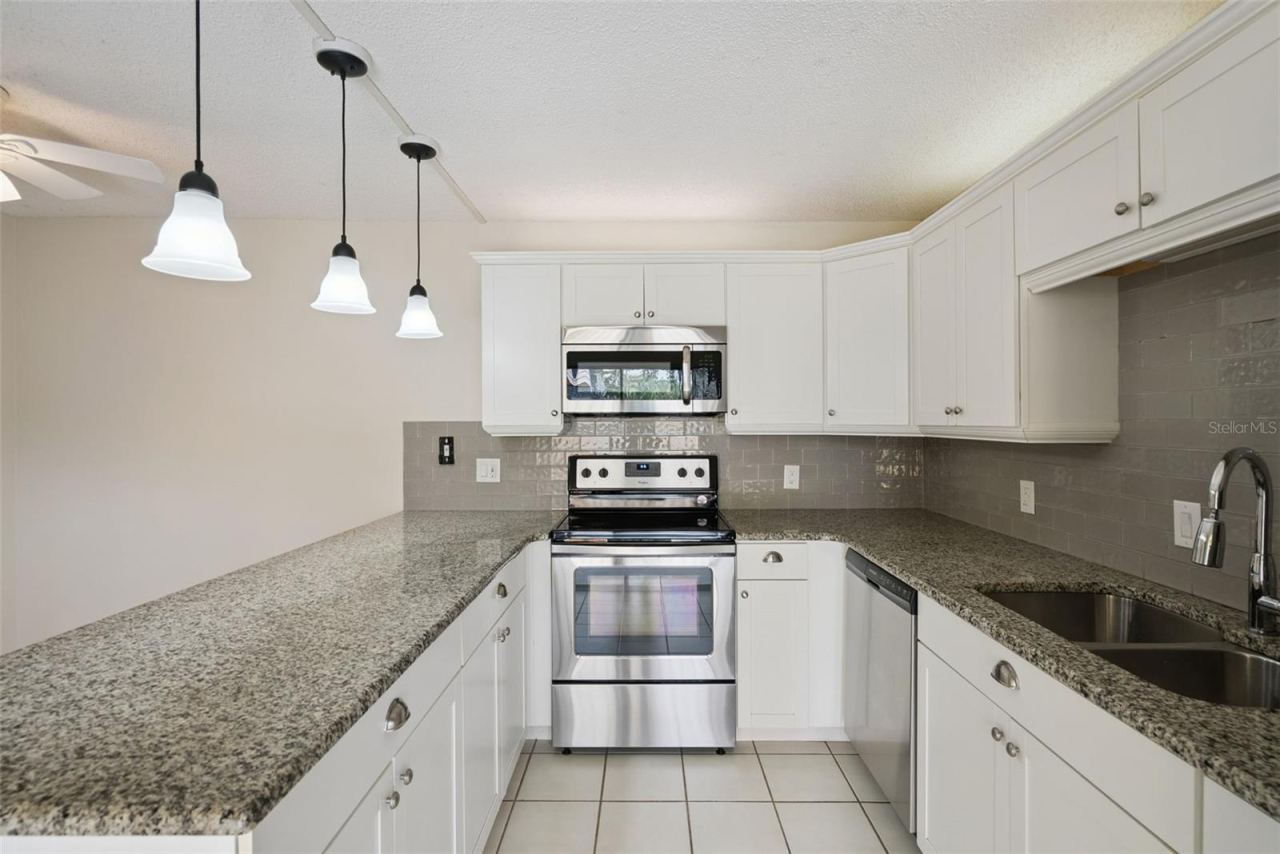 Photo 18 of 20: Eat-In Kitchen with access to guest bathroom on 1st floor