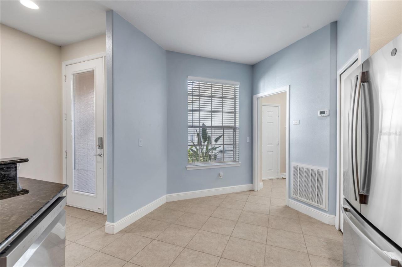 Photo 11 of 20: front door entry way leading into the kitchen, further into the laundry and garage