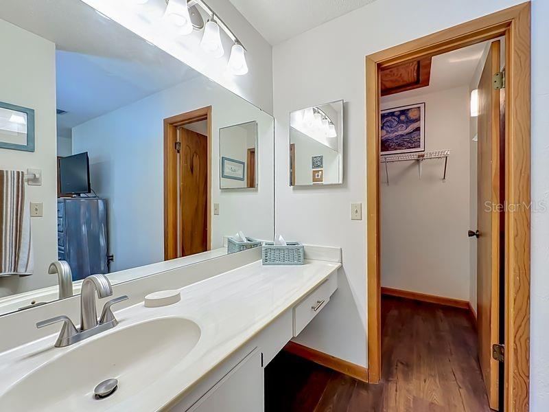 Photo 18 of 20: Primary Bathroom. Extended single vanity -full wall mirror-walk in closet