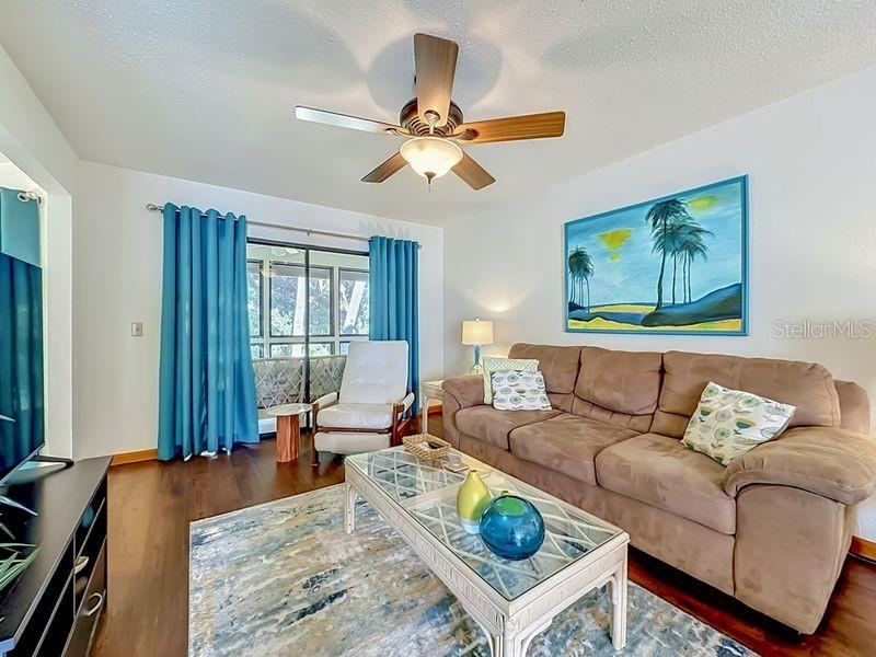 Photo 6 of 20: Living Room-Bright and open with Engineered wood flooring and sliders to Florida Room