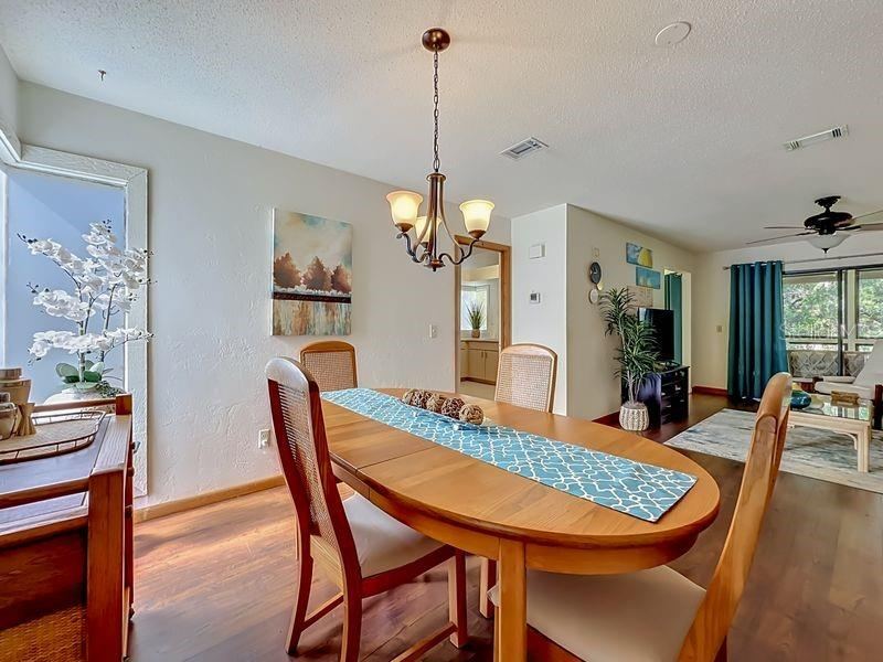 Photo 5 of 20: Dining Room view 2 toward Living room. Engineered wood flooring.