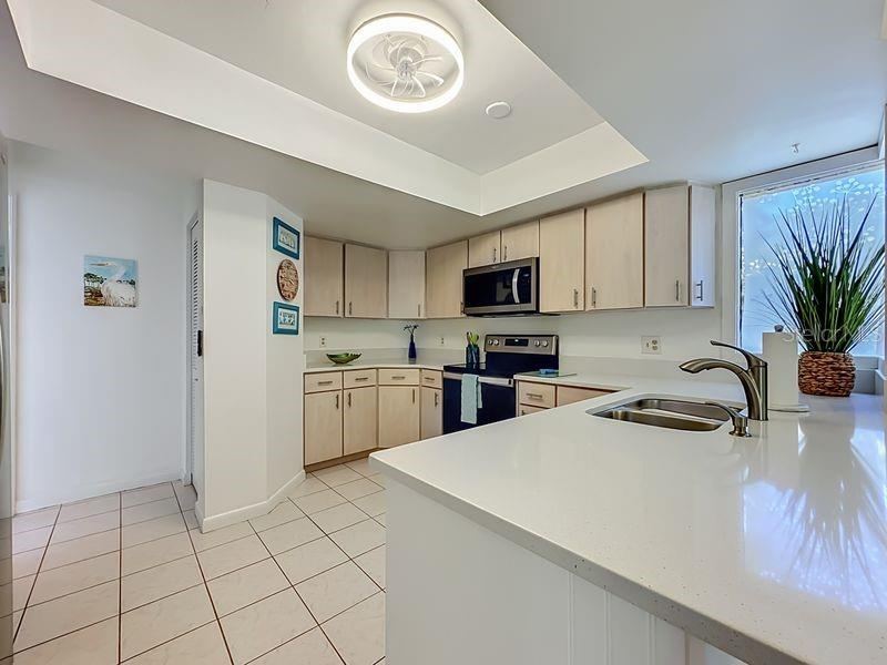 Photo 12 of 20: Kitchen High Ceiling -Stainless Steel Appliances-Pantry and stackable washer and Dryer closet.