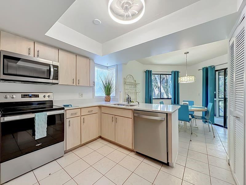 Photo 11 of 20: Kitchen Stainless Steel Appliances-Open to Cafe Nook