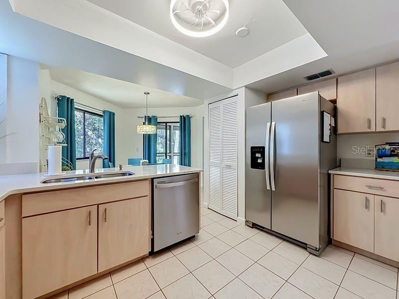 Photo 13 of 20: Kitchen High Ceiling -Stainless Steel Appliances-Pantry and stackable washer and Dryer closet.