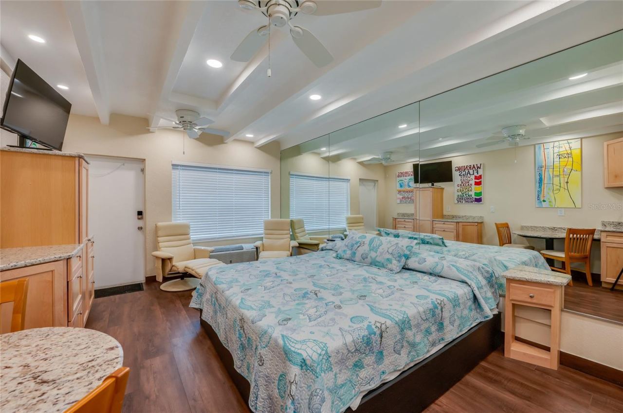 Photo 19 of 20: Alternative view of the main living space, highlighting the versatile furniture arrangement and the bright, airy feel of the interior.