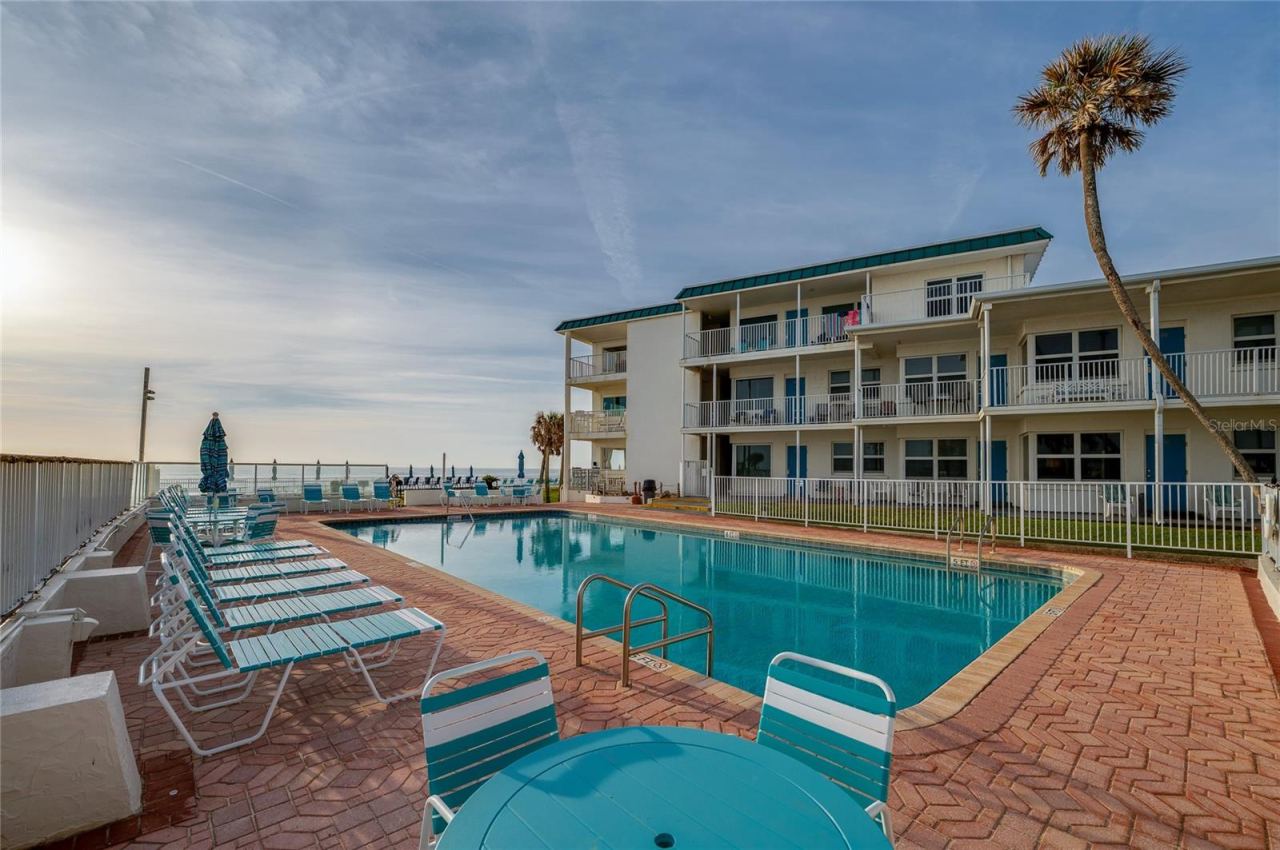 Photo 4 of 20: Large, crystal-clear swimming pool surrounded by a spacious sun deck with premium lounge chairs. The ocean breeze and panoramic views create a true vacation atmosphere.