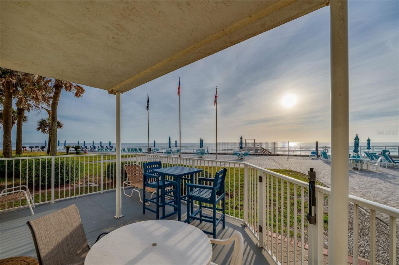 Photo 7 of 20: Spacious covered patio featuring versatile seating options, including a high-top bistro set and lounge chair.
