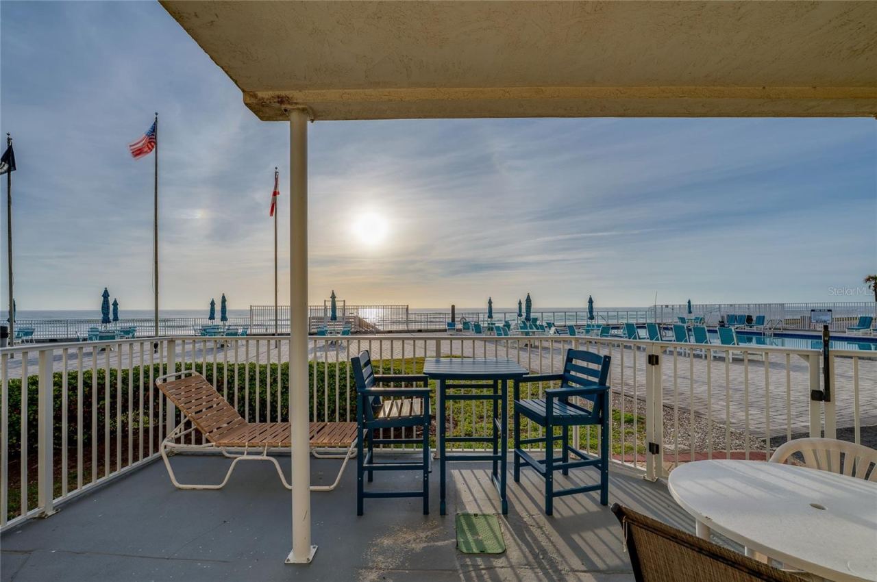 Photo 6 of 20: Private ground-floor patio offering stunning, unobstructed views of the Atlantic Ocean and the community pool.