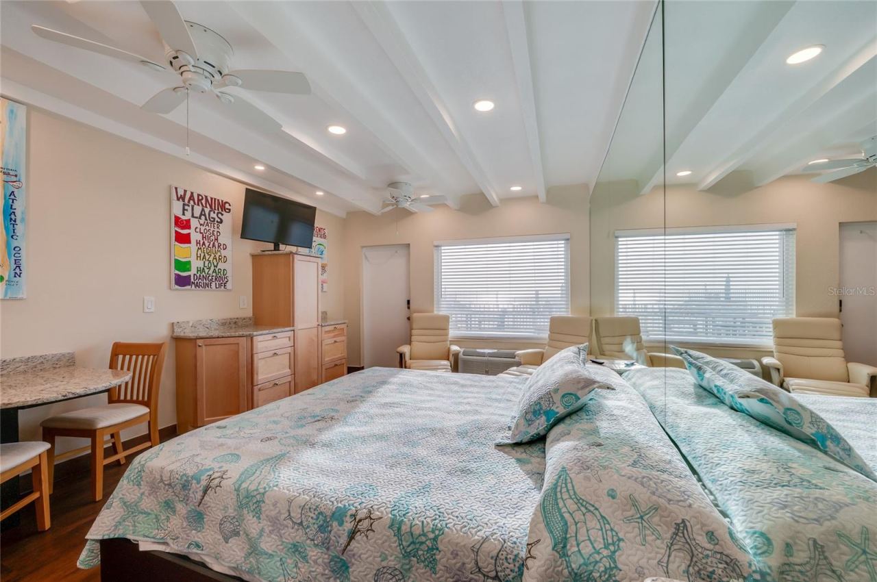 Photo 18 of 20: Inviting sleeping area tucked into the studio's "easy-flow" floor plan, creating a restful atmosphere without sacrificing the open feel of the unit.