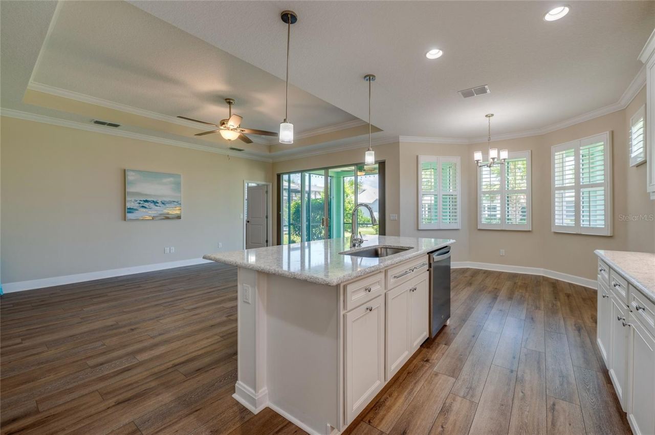 Photo 12 of 20: View from behind the kitchen island looking out into the living area and dining nook, highlighting the fluid open-concept design.