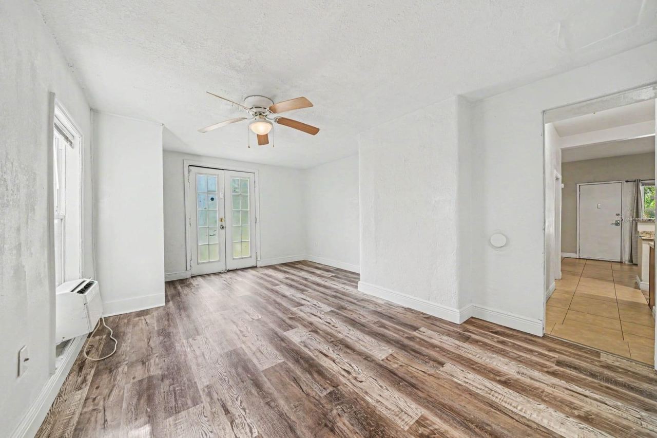 Photo 18 of 20: Spacious Living Area with Wood Floors, French Doors & Ceiling Fan