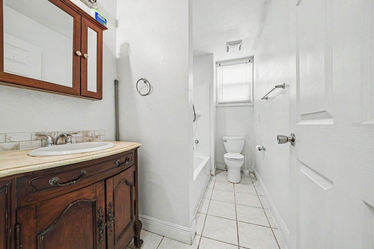 Photo 17 of 20: Master Bath with Wood Vanity, Separate Tub & Shower, Tile Flooring