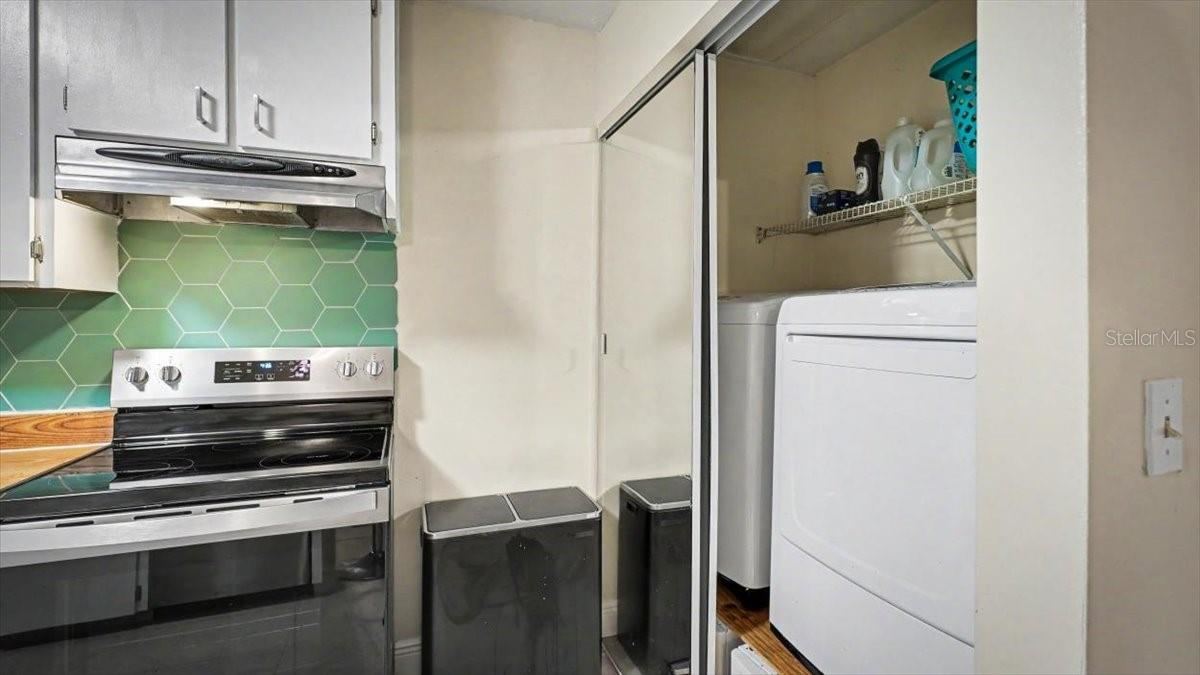 Photo 14 of 20: Kitchen with laundry and full size washer & dryer with storage drawers underneath