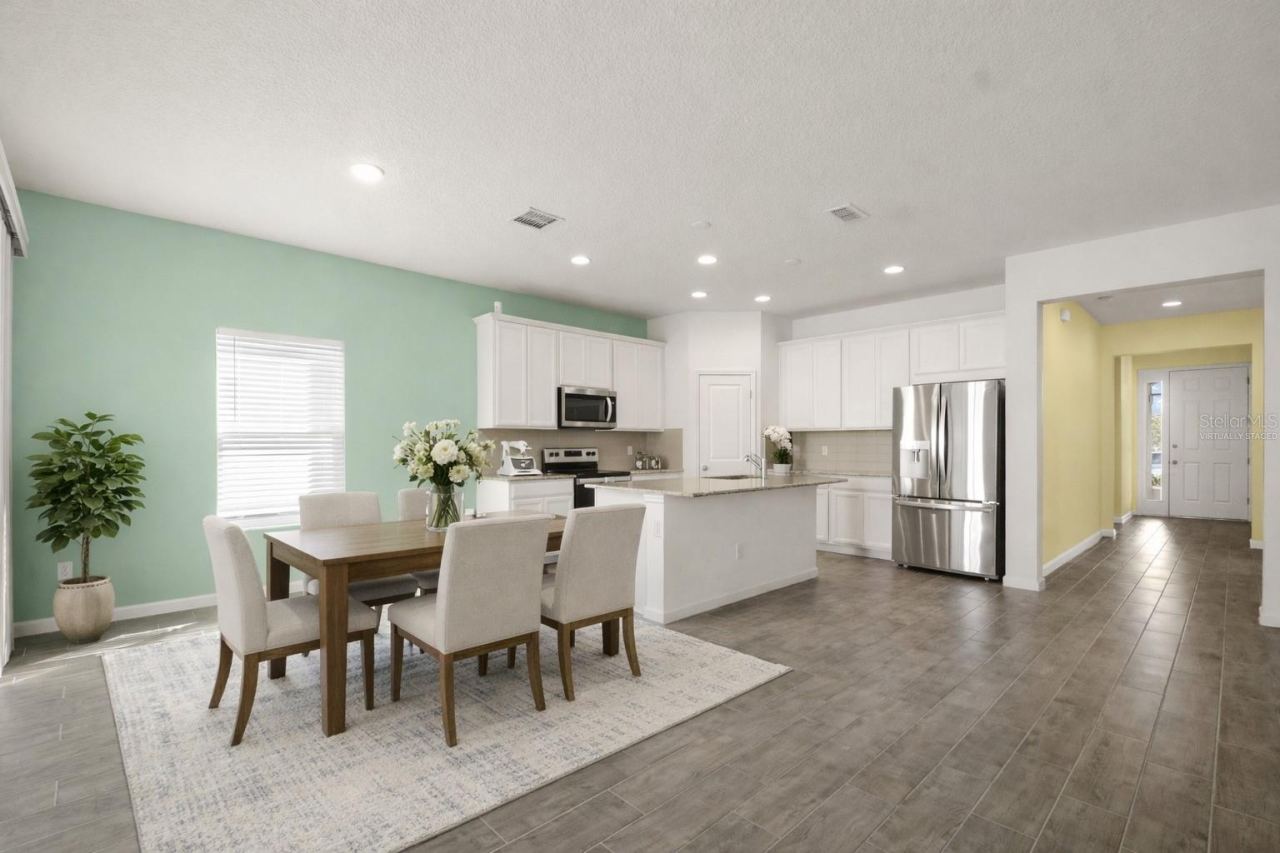 Photo 10 of 20: This photo has been virtually staged. Kitchen and Dining room view from Living Room.