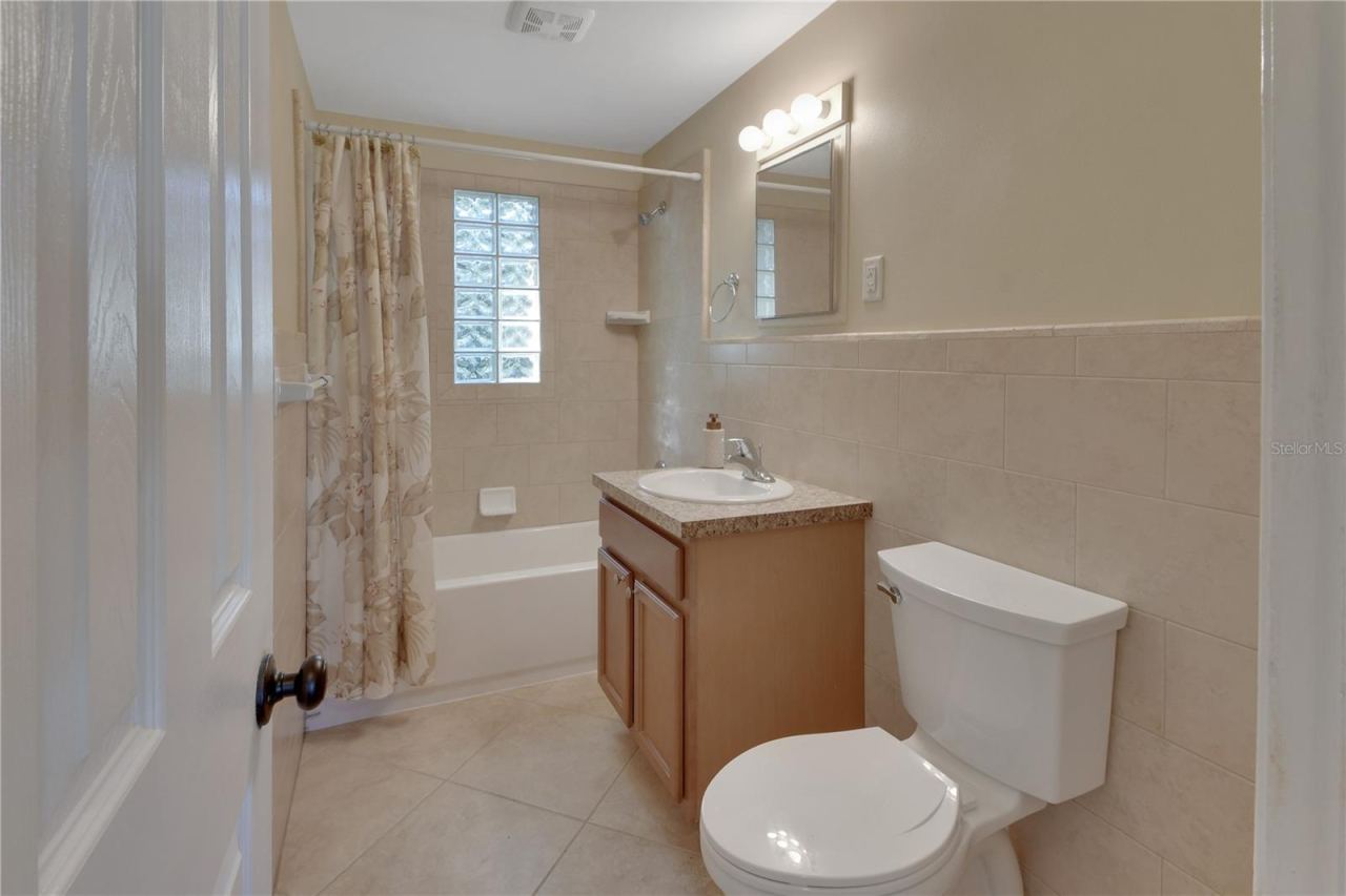 Photo 13 of 20: Spacious bathroom with tiled walls and new toilet