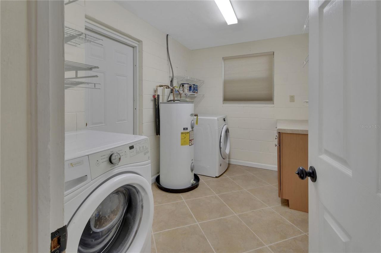 Photo 16 of 20: Laundry and storage leads to back yard