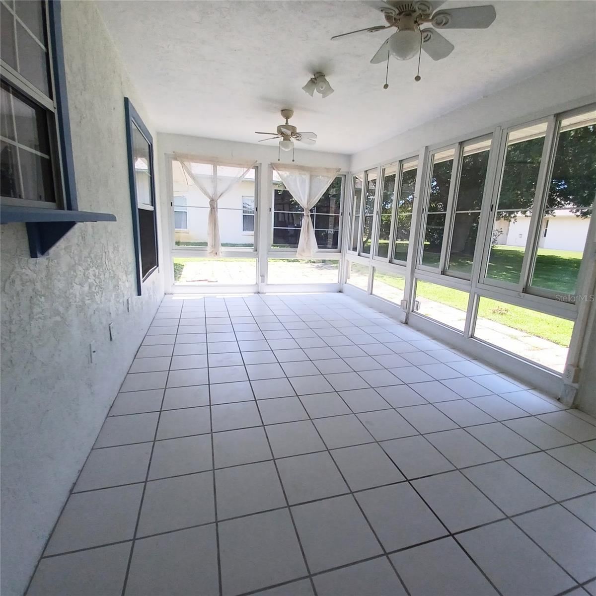 Photo 17 of 20: Beautiful big Florida Room with kitchen pass-through window.