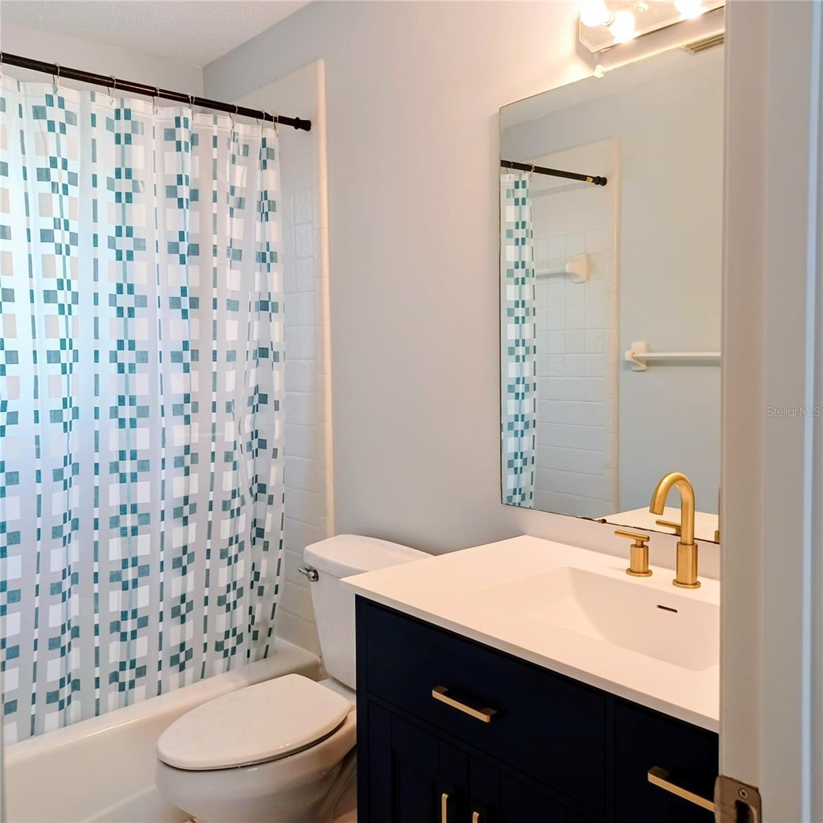 Photo 18 of 20: Second bath, tub shower combo. New vanity