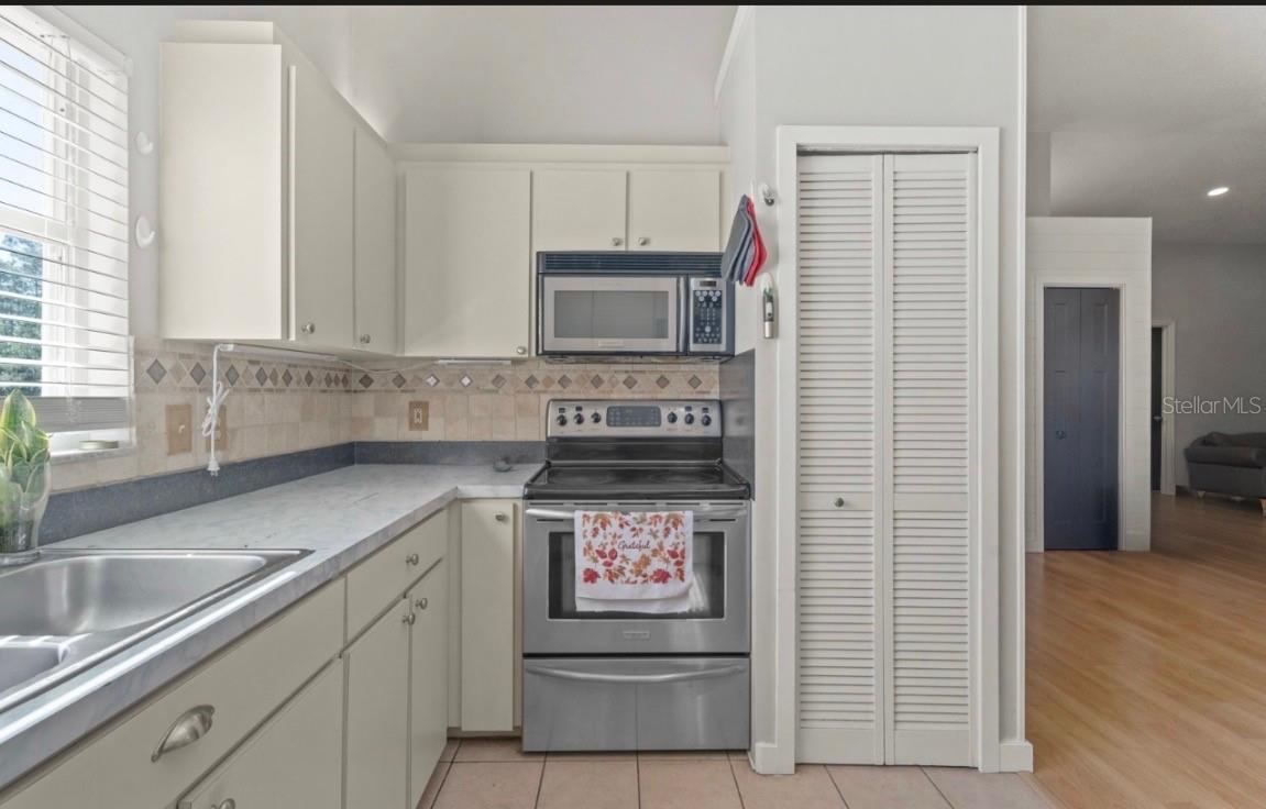 Photo 14 of 20: Open Kitchen with newer stainless steel appliances.