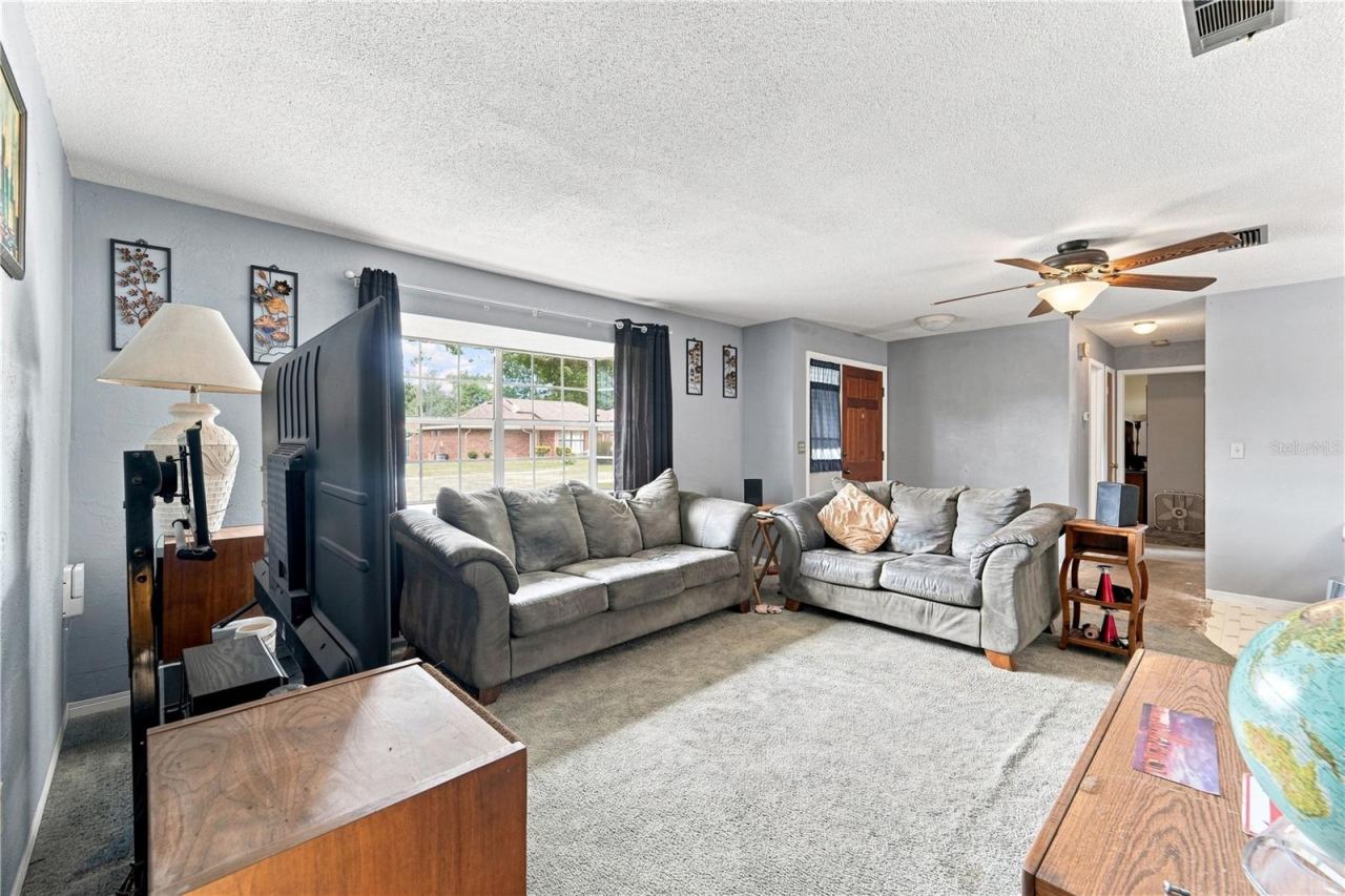 Photo 3 of 16: Natural light fills the spacious living room—imagine the possibilities with your own updates and style.