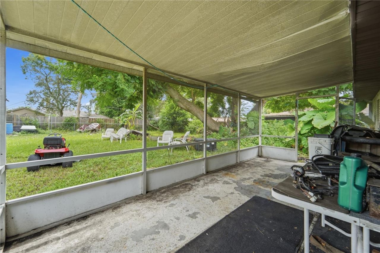 Photo 12 of 16: Step outside to the screened rear porch and imagine the possibilities for this outdoor space.