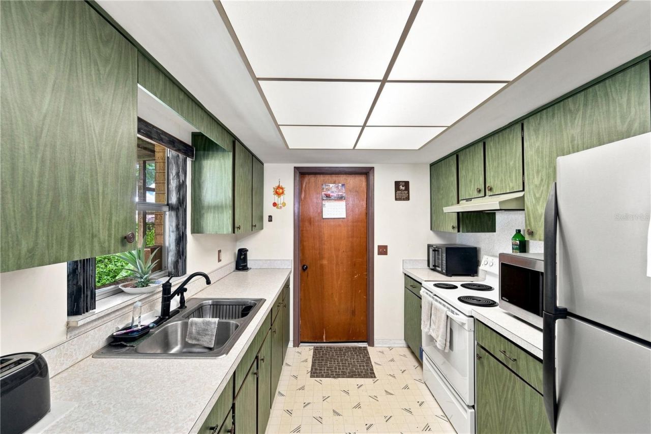 Photo 5 of 16: Ready for a refresh! This galley-style kitchen offers abundant cabinetry and counter space.