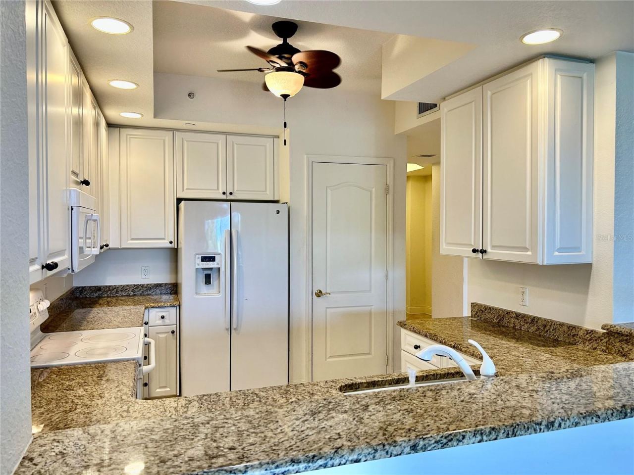 Photo 4 of 20: Granite kitchen counters, white cabinets & pantry.