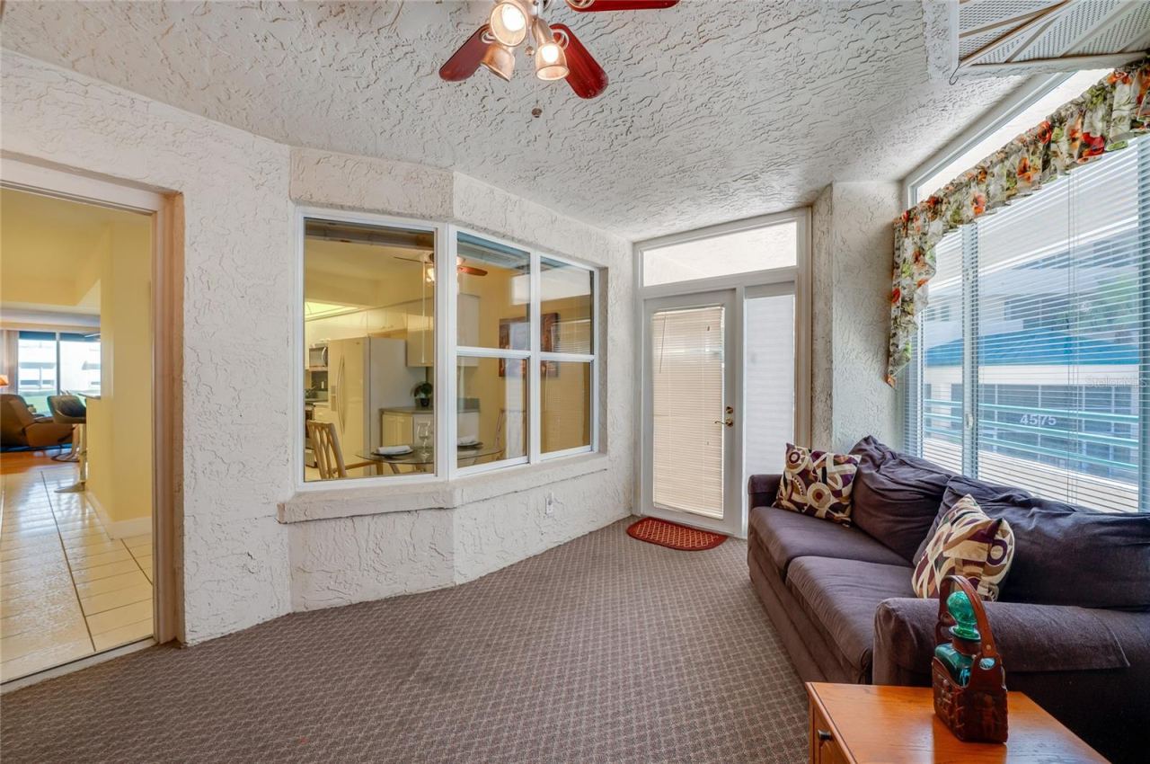 Photo 8 of 20: Another angle of the sunroom highlights its versatile layout, with large windows and a view to the inside, creating a seamless indoor-outdoor living experience.