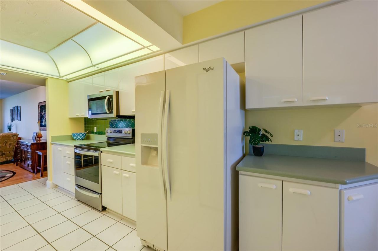 Photo 13 of 20: The well-appointed kitchen includes abundant cabinetry, expansive countertops, and a full suite of appliances, offering both style and practicality for meal preparation.