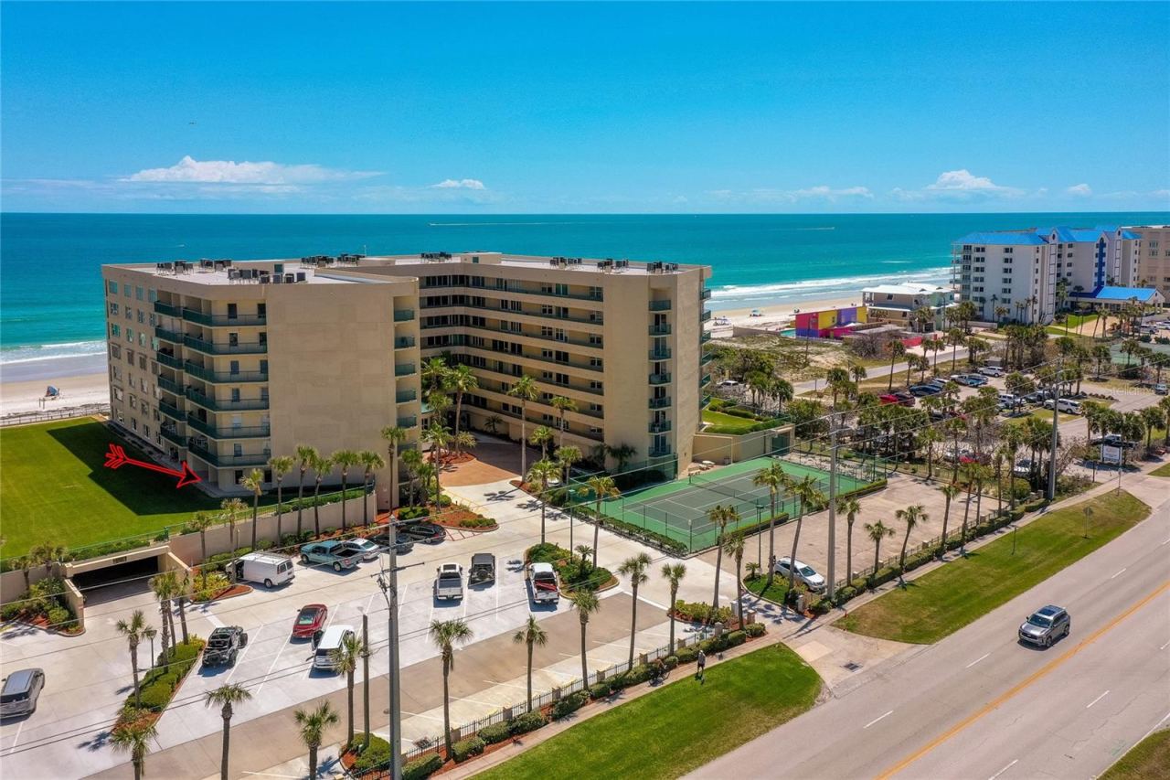Photo 3 of 20: Oblique aerial showcasing the property’s coastal positioning with easy access to both the ocean and nearby roadways.