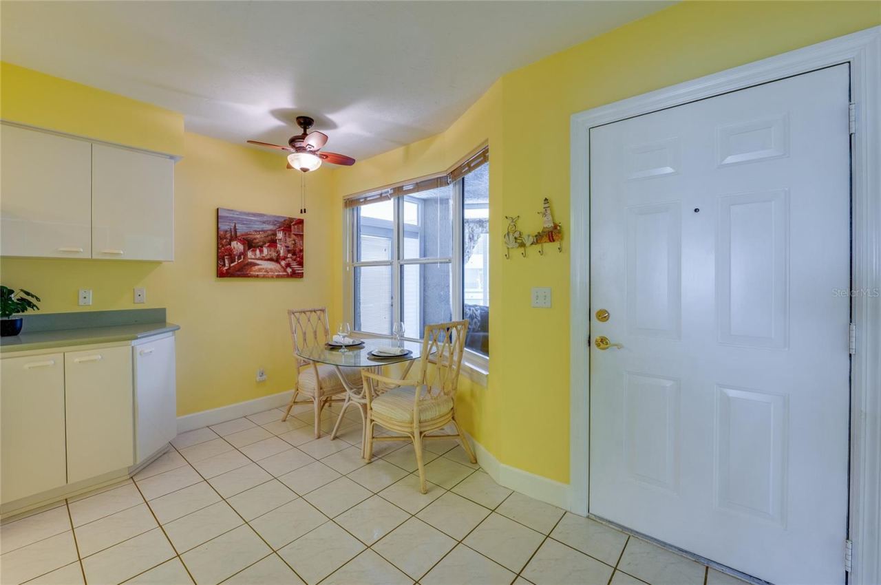 Photo 12 of 20: A charming breakfast area with large windows provides a bright setting for casual dining, enhanced by natural light and easy access to the kitchen.