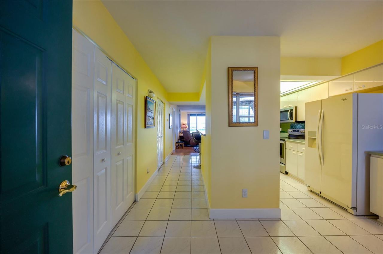 Photo 10 of 20: A welcoming entry opens to a spacious hallway with tile flooring, leading into the main living areas and adjacent rooms.