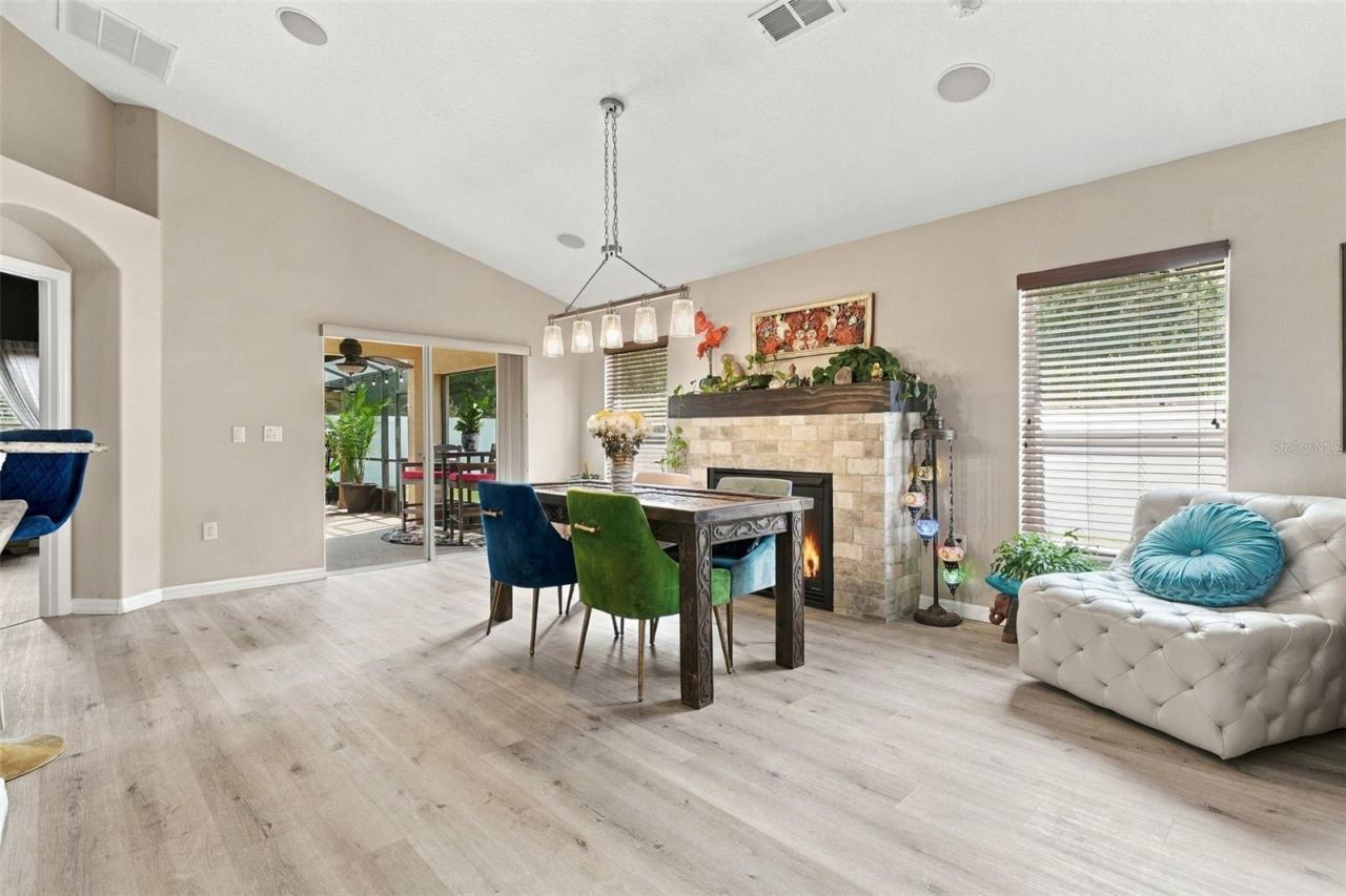 Photo 16 of 20: Dining area towards fireplace and screened rear lanai.